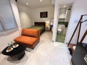 a bedroom with a bed and a chair and a table at Cỏ Lá Homestay in Danang +22 photos