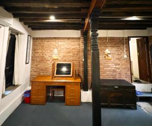 a room with a desk with a tv on it at Newa Inn Homestay in Kathmandu