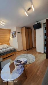a room with a bed and a table and a couch at U Bizioma in Murzasichle