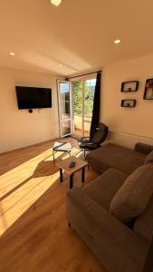 a living room with a couch and a tv at Apartmány Pod Stráží in Sušice