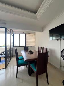 a dining room with a wooden table and chairs at aprtamento CTG in Cartagena de Indias
