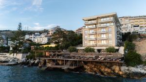 a bridge over the water next to a building at DAED Luxury Residence in Sarandë