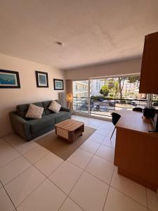 a living room with a couch and a table at Ti Gon - Le Cabanon Baulois in La Baule