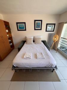 a bedroom with a bed with two pillows on it at Ti Gon - Le Cabanon Baulois in La Baule