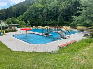 a swimming pool with a slide in the middle at Apartment P&T Top 5 in Altenhof