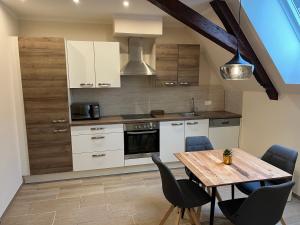 a kitchen with a wooden table and a dining room at Apartment P&T Top 5 in Altenhof