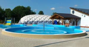 a large circular pool in front of a domed building at Apartament Międzylesie in Międzylesie