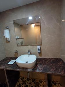 a bathroom with a sink and a mirror at Hotel Maurya Heritage In Karol Bagh in New Delhi +50 photos
