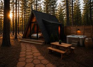 a small tent with a bed and a table in a forest at Ponderosa Pines Resort in Parks
