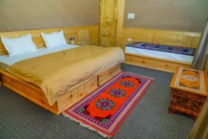 a bedroom with two beds and a table and a mirror at Eco Residence Pangong in Lukung +34 photos