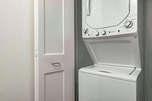a white washer and dryer next to a door at WorldMark Kihei in Kihei +46 photos