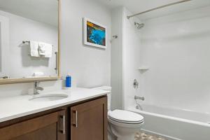 a bathroom with a toilet and a sink and a tub at WorldMark Kihei in Kihei
