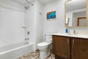 a bathroom with a toilet and a sink and a tub at WorldMark Kihei in Kihei