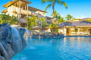 a pool at a resort with a waterfall at WorldMark Kihei in Kihei