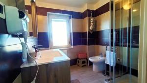 a bathroom with a sink and a shower and a window at B&B Catanzaro lido La collina dei poeti in Catanzaro Lido