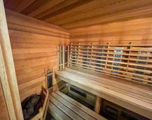 a sauna with wooden walls and a wooden bench at The Perch - Spa & Pool in Beaupré