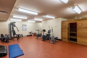 a gym with several treadmills and exercise bikes at The Perch - Spa & Pool in Beaupré