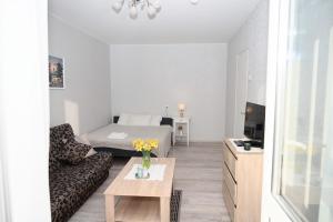 a living room with a bed and a couch at Side Apartments in Rakvere +12 photos