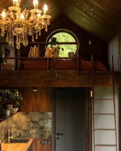 a chandelier and a window in a room with a kitchen at Silence cabin in Myta +20 photos