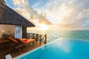 a resort with a swimming pool and the ocean at Sun Siyam Vilu Reef with Free Transfer in Dhaalu Atoll