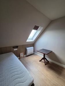 a attic bedroom with a bed and a window at Erve Ther Maet in Weerselo