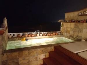 a jacuzzi tub with candles on top of it at Spacious 4BR Duplex with Pool in Punta Hermosa in Punta Hermosa +10 photos