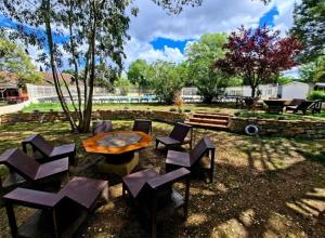 a group of chairs and a table in a yard at camping des iscles 167 in La Roque-dʼAnthéron