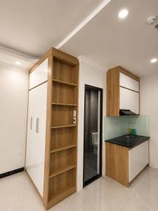 a kitchen with wooden shelves and a toilet in a room at Dreamora Serenity Hotel & Residence in Hanoi +5 photos