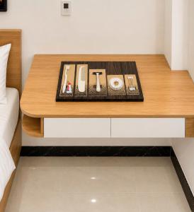 a table in a room with a bed and a table with food at Dreamora Serenity Hotel & Residence in Hanoi