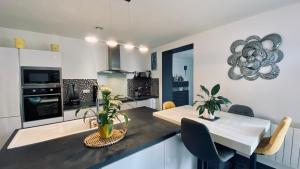 a kitchen with a table and a dining room at Sabrina in Tarbes