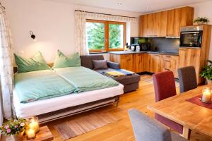 a living room with a bed and a kitchen at Chalet Leni in Schladming