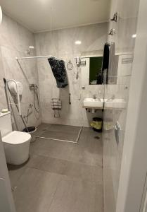 a bathroom with a shower and a toilet and a sink at Hostel BM19 in Madrid +11 photos