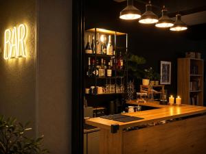 a bar with a wooden counter in a room at DOMES APARTMENTS in Kallithea Halkidikis