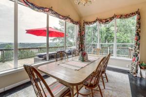 a dining room with a table and chairs and a large window at Sunset View Deck! Lake Eufaula Family Getaway in Stigler