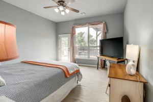 a bedroom with a bed and a desk and a window at Sunset View Deck! Lake Eufaula Family Getaway in Stigler