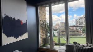 a room with a window with a view of a city at The Apex Penthouse, Hyde Park in London