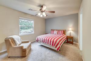 a bedroom with a bed and a chair and a ceiling fan at Sunset View Deck! Lake Eufaula Family Getaway in Stigler
