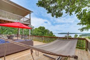 a hammock on the deck of a house at Sunset View Deck! Lake Eufaula Family Getaway in Stigler