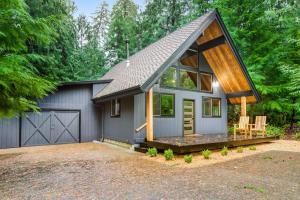 a small house with a gambrel roof and a garage at Alderbrook A-Frame in Union