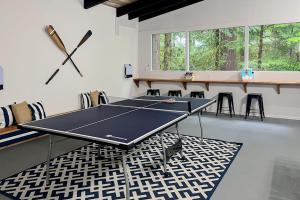 a ping pong table in a room with chairs at Alderbrook A-Frame in Union