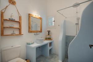 a bathroom with a sink and a toilet and a mirror at Villa Ostria in Rámos +58 photos