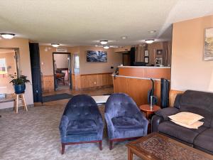 a living room with two chairs and a couch at East Grand Inn Grand Forks ND I 29 in East Grand Forks