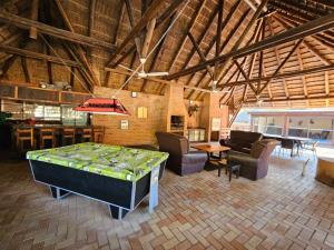 a room with a bed and chairs and a table at THE PONT port Edward UNIT 1 in Port Edward
