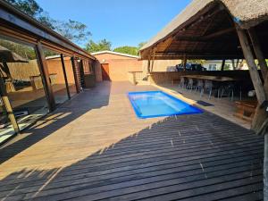 a wooden deck with a swimming pool on a house at THE PONT port Edward UNIT 1 in Port Edward