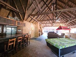 a room with a bar and a table and chairs at THE PONT port Edward UNIT 1 in Port Edward