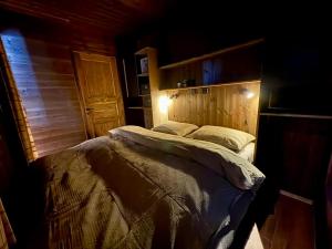 a bedroom with a large bed with a wooden headboard at Mountain Stable Apartment Beito in Beitostøl