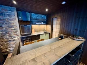 a kitchen with a large wooden counter in a room at Mountain Stable Apartment Beito in Beitostøl