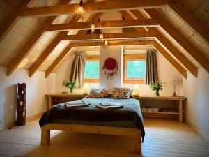a bedroom with a bed in an attic at Górska Osada Berdo in Chmiel