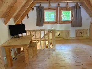 a room with a desk with a computer on it at Górska Osada Berdo in Chmiel