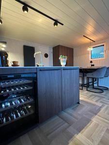 a kitchen with a counter with a bunch of wine bottles at De Waterlodge - Uniek verblijf aan het water in Franeker